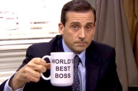 A picture of Michael Scott, from The Office US, with a mug that says "Worlds best boss"